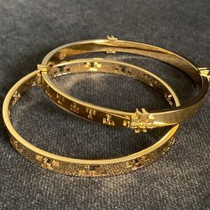 Gold tone Tory Burch bangle bracelets.